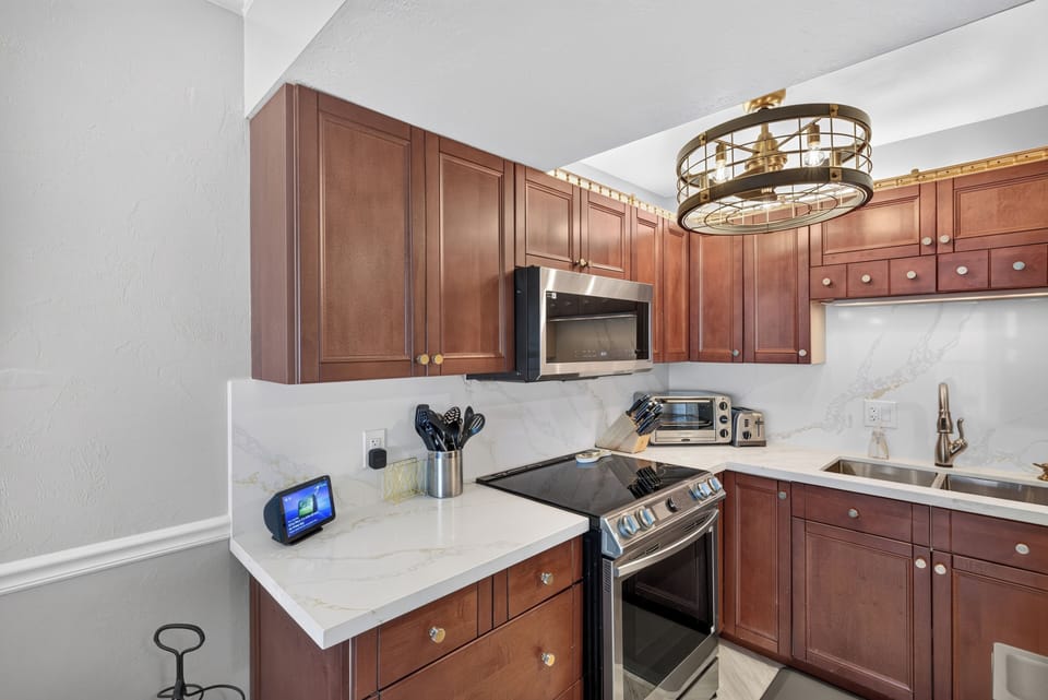 Induction cooktop, built in air fryer, quartz countertops, & marble floors. 