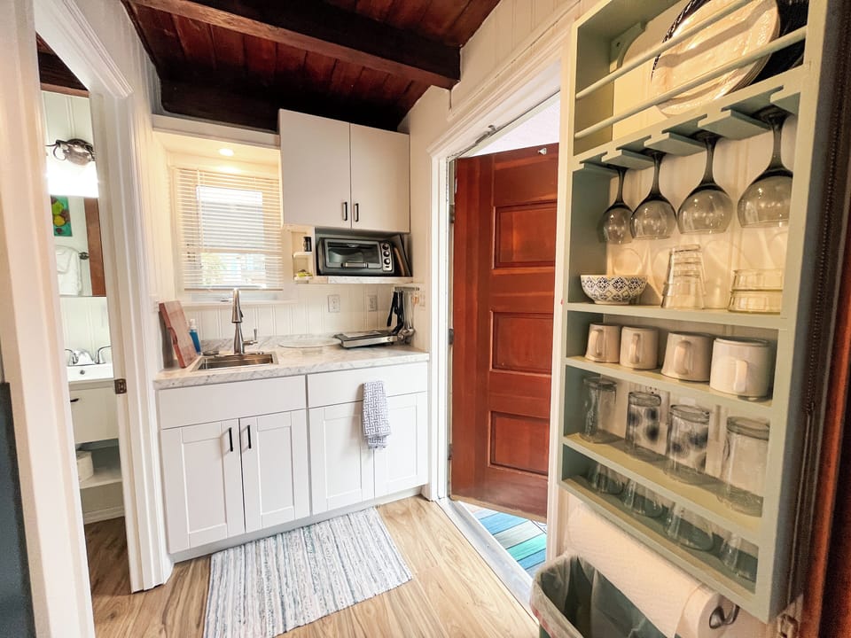 Fully-equipped with a toaster oven, microwave, coffee maker, & fridge/freezer.