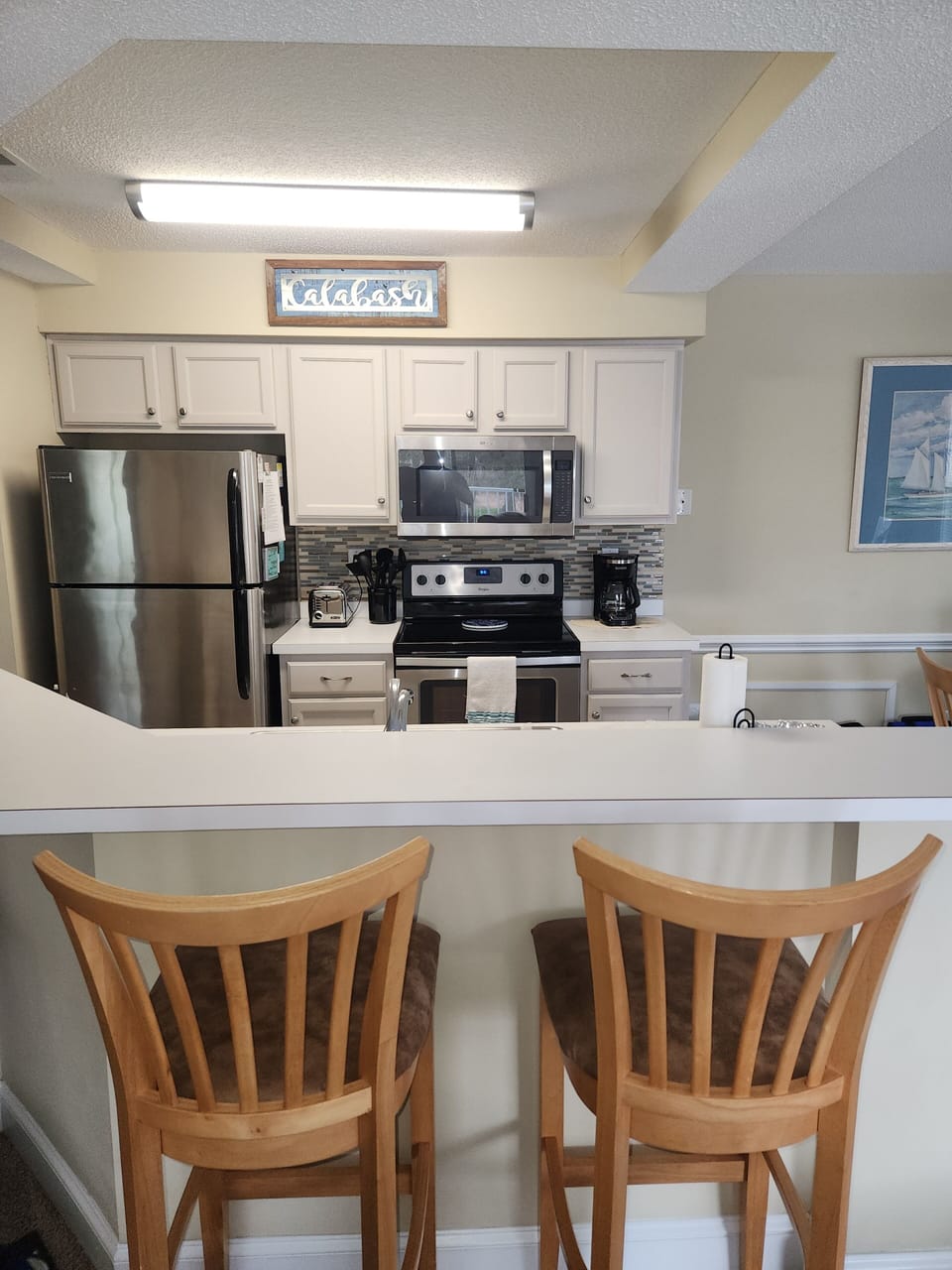 The kitchen counter with 2 bar stools.