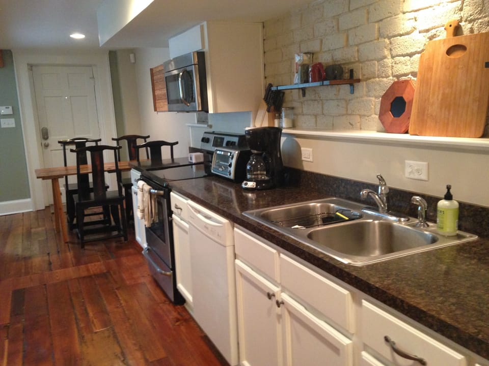 Fully stocked kitchen is open to living room and dining area.