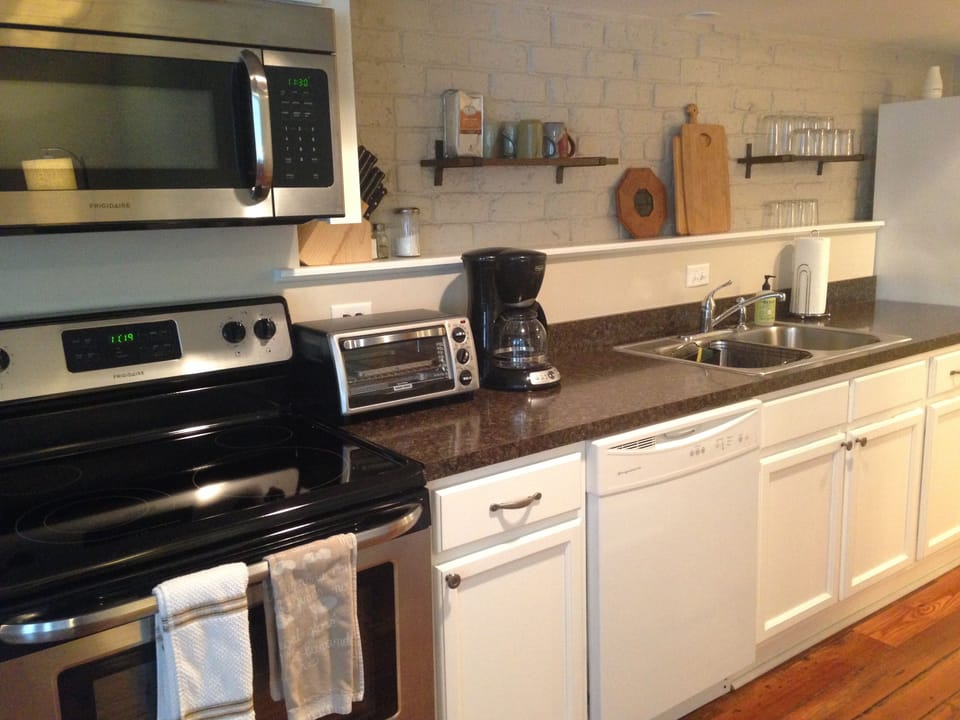 Kitchen is stocked with all the pots, pans, utensils, etc required for cooking.