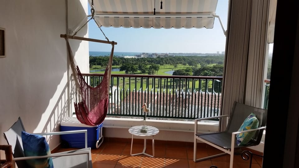 Relax in the breezy balcony with a spectacular view.