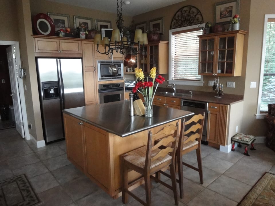 Gourmet  kitchen with maple cabinets,  stainless steel island & GE appliances.