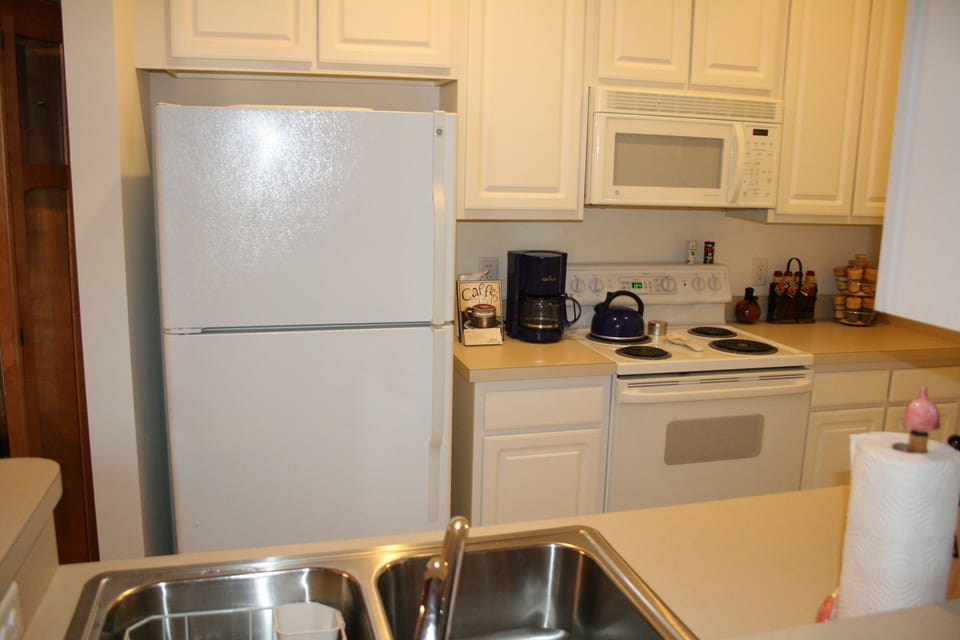 The kitchen is stocked with all appliances including a dishwasher.