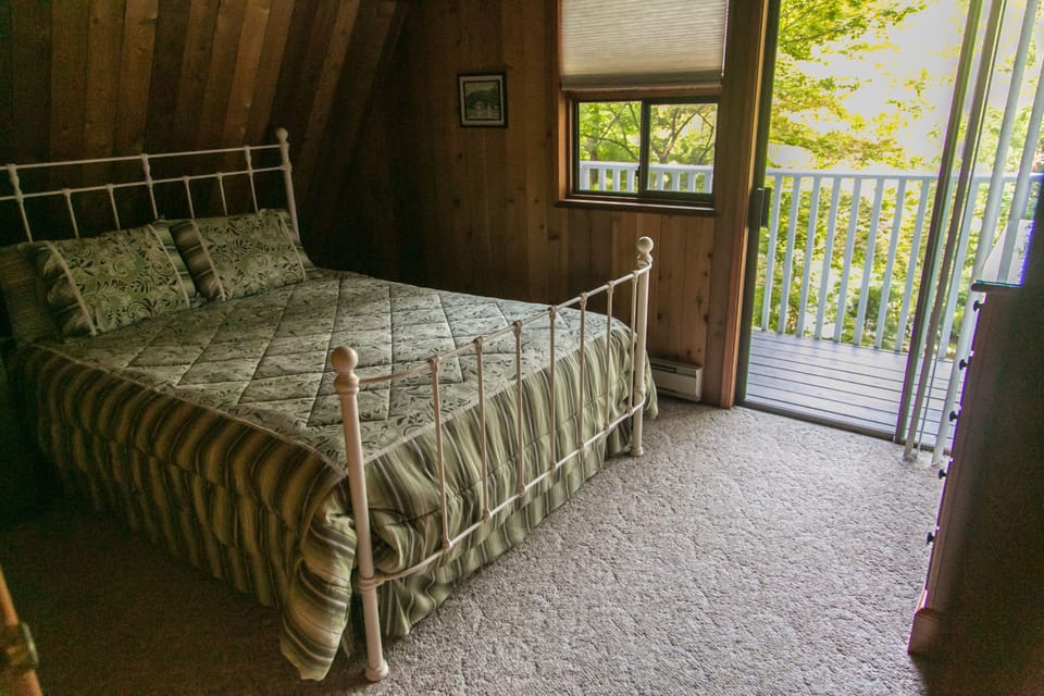 Bedroom #3 with queen bed and balcony with views of the lake.
