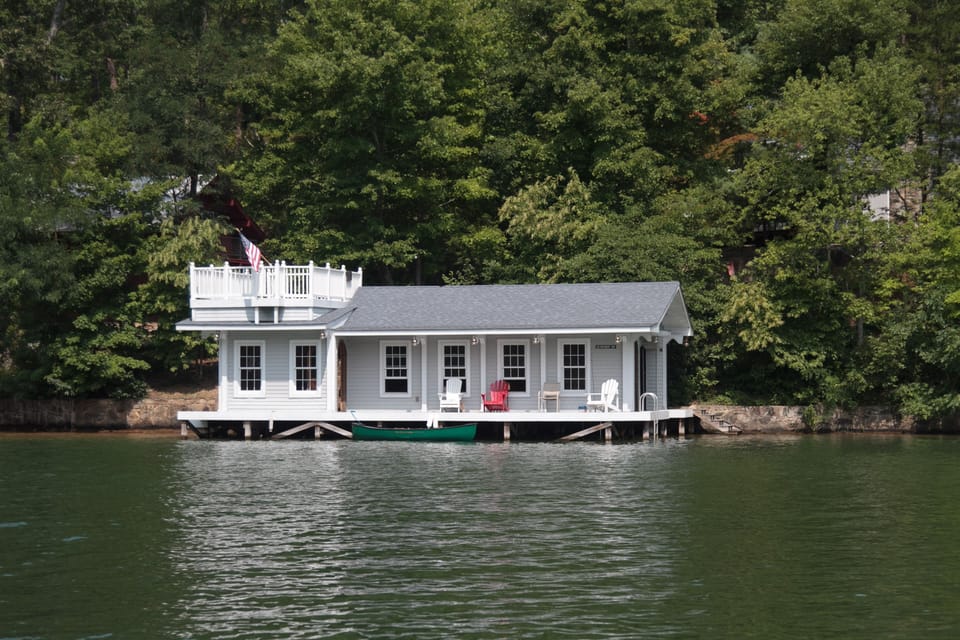 View of the boathouse from the cove. Cottage seen on the right thru the trees.