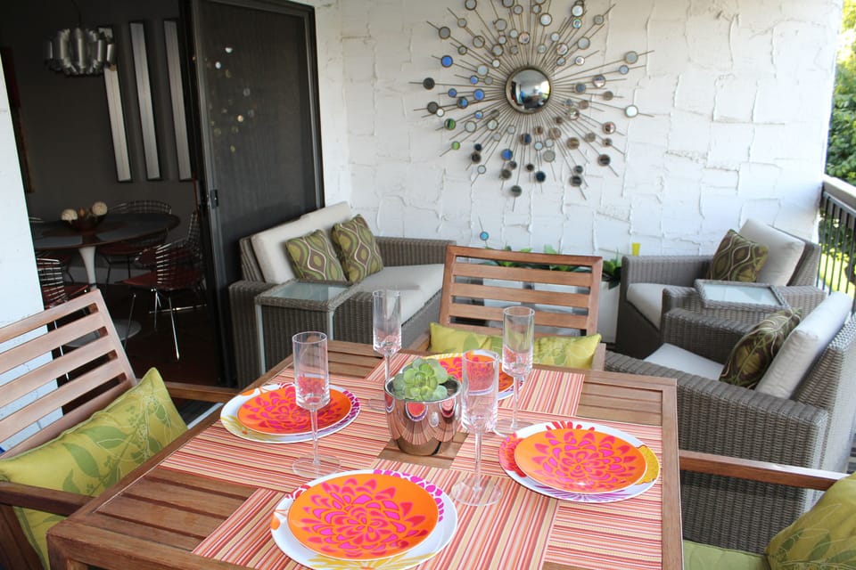 Patio dining and sitting area overlooking pool