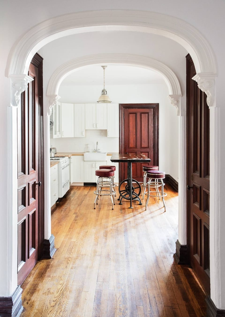 open hallway with a storage closet that enters into the kitchen