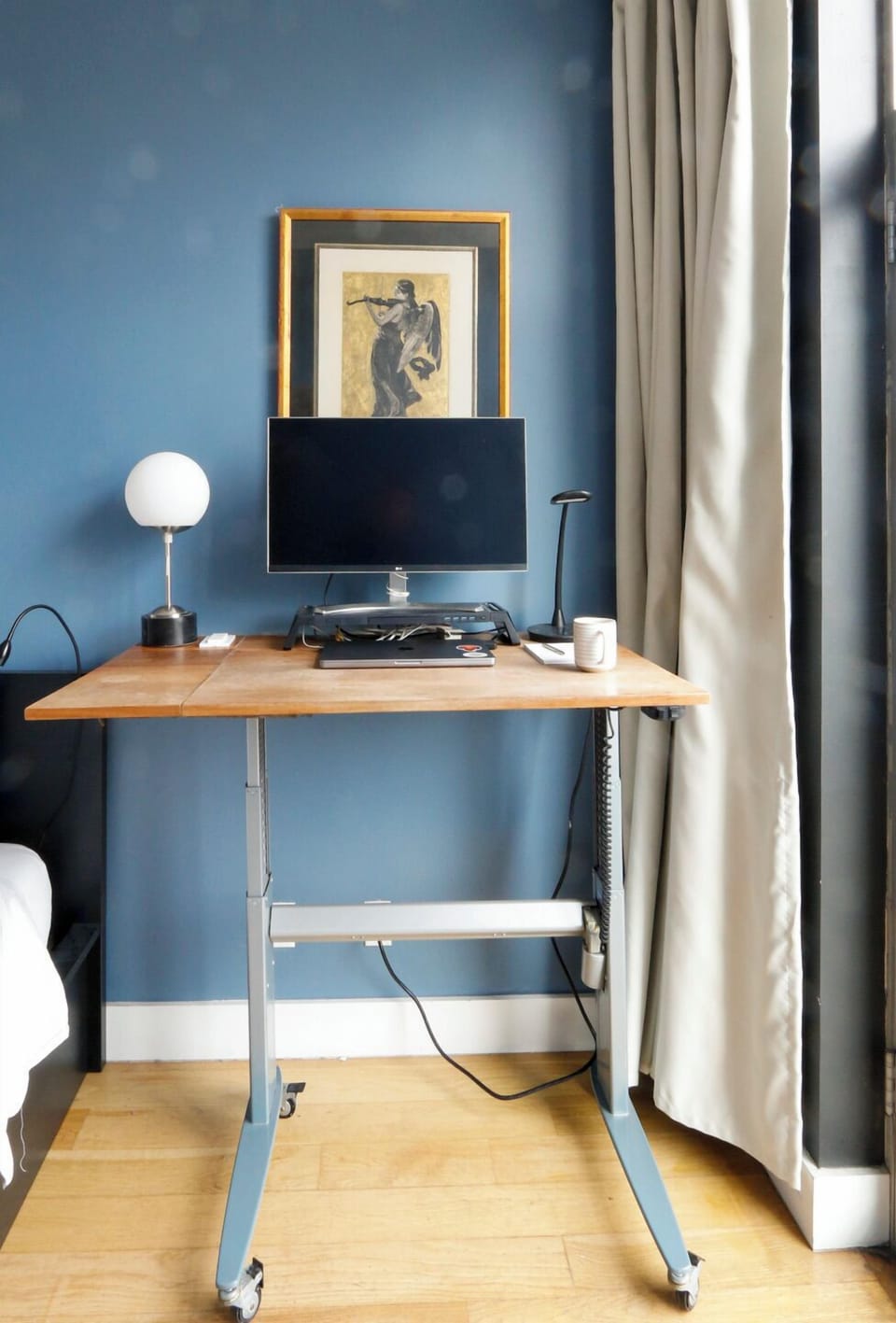 The desk in the second bedroom  raised to stand-up height.