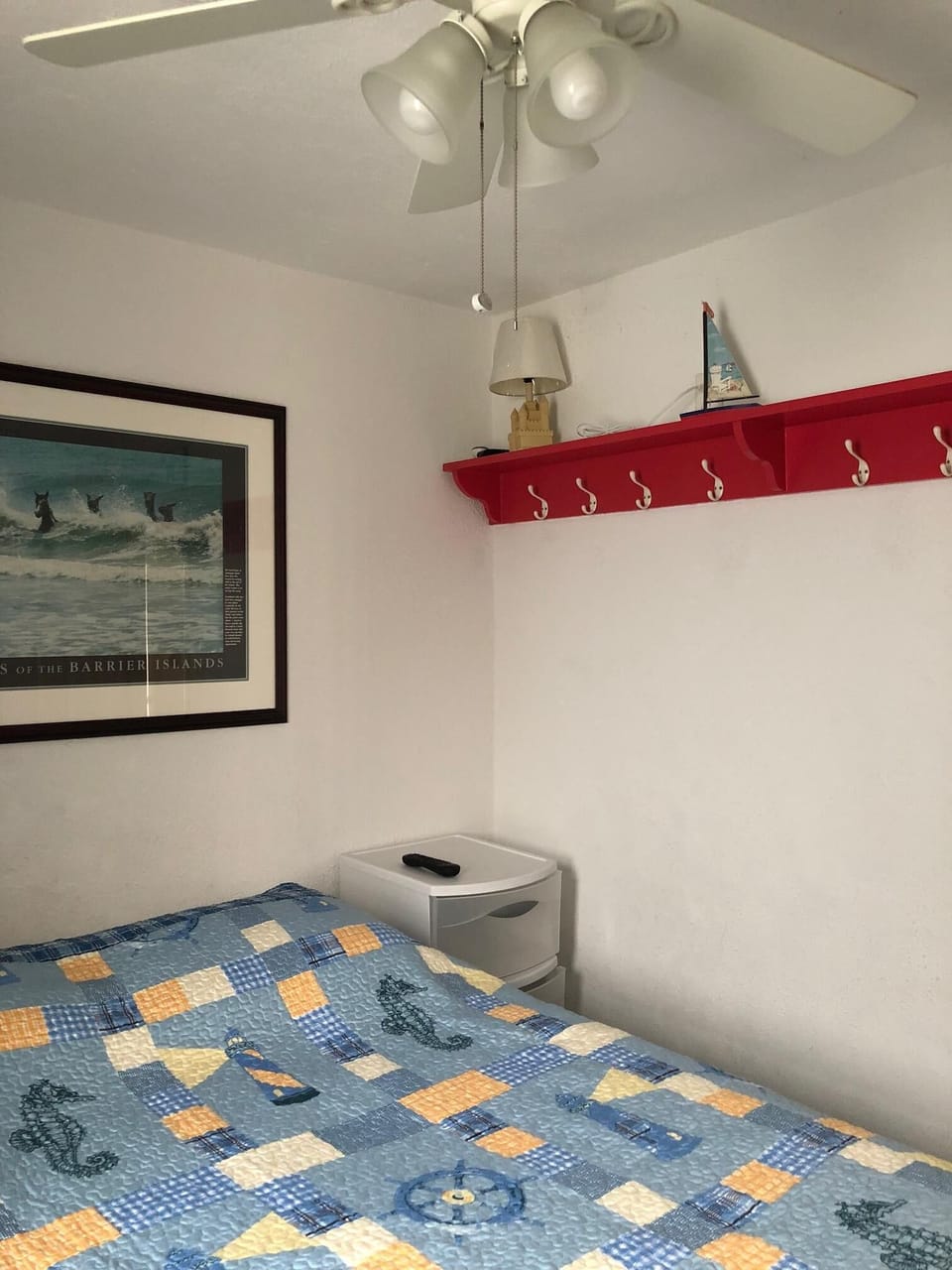 Third view of bedroom with wall hangers