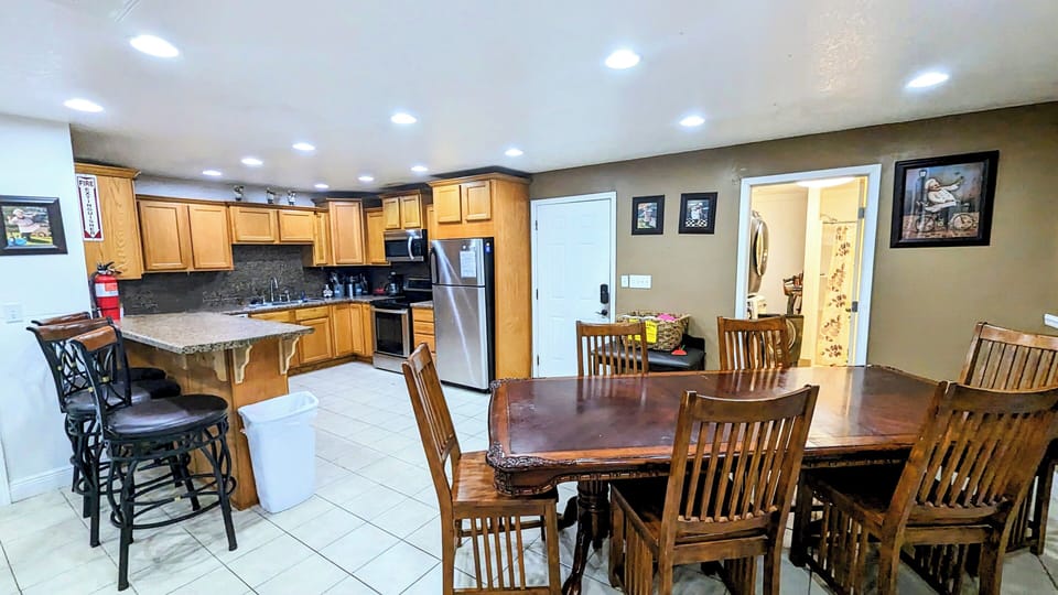 Kitchen and dining area with side laundry room with extra full bath.