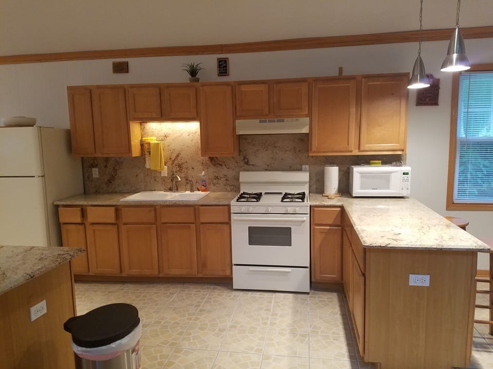 Kitchen has modern appliances including small freezer in mud room