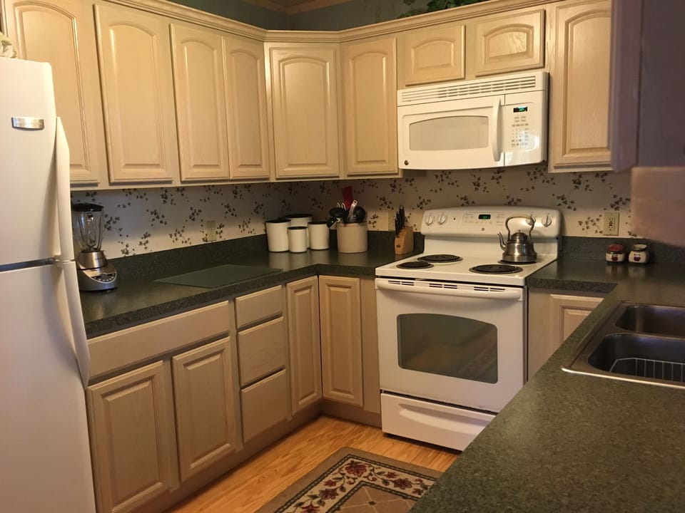Main level kitchen is fully equipped with dishes, linens, and appliances.