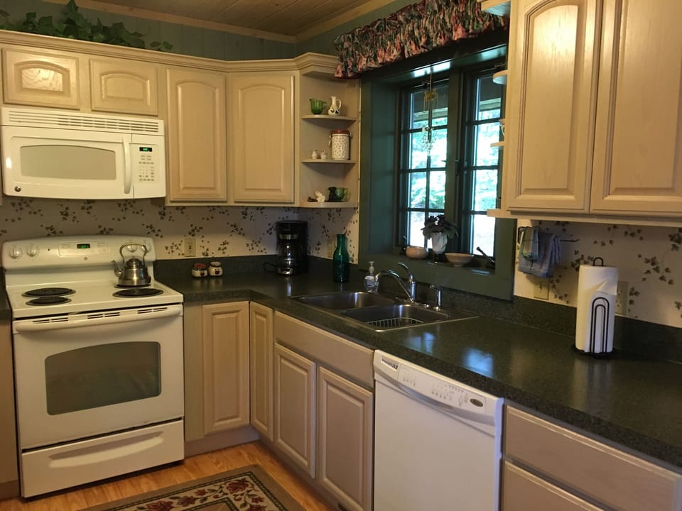 Main kitchen has a view of the mountains and forest.