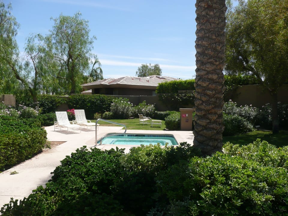 Hot Tub and Grassy Area for Sunning and Relaxing.