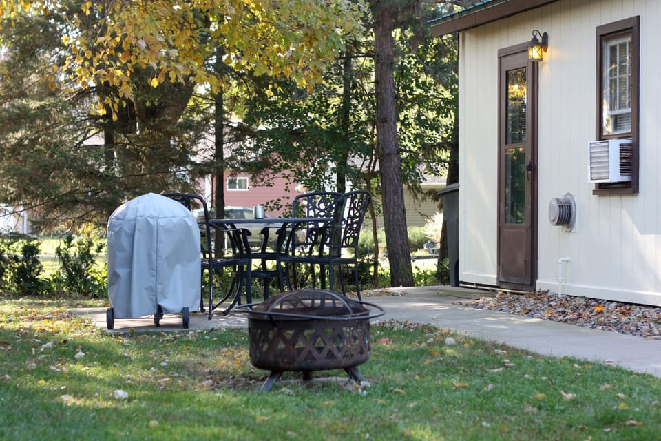 Each cabin has its own patio with table, chairs, fire pit, and charcoal grill.