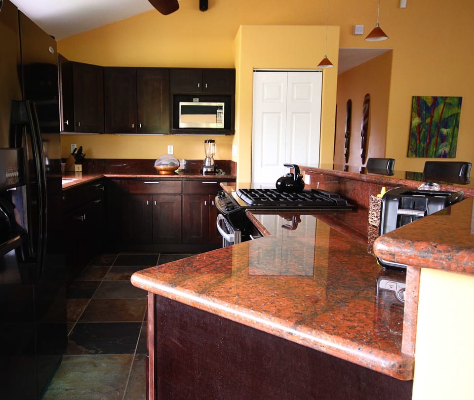 Well stocked custom kitchen with granite counters