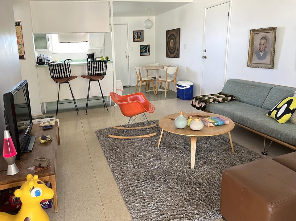 Bright and airy living room with modern kitchen access