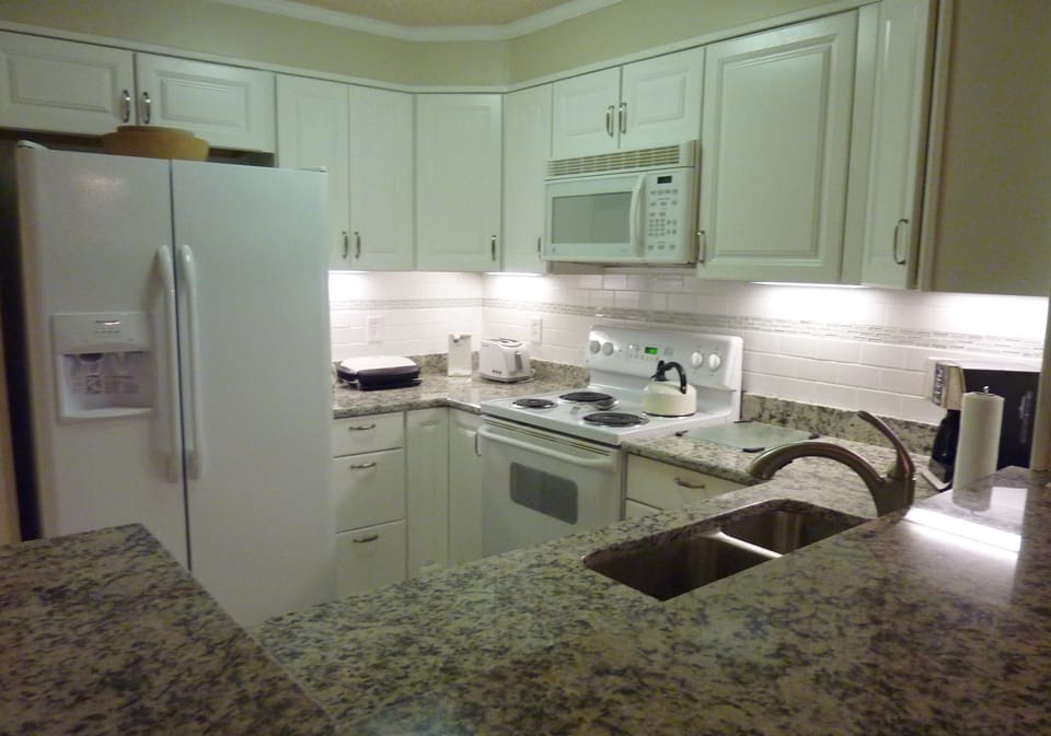 Updated kitchen with granite counters, new cabinets, refrigerator and dishwasher