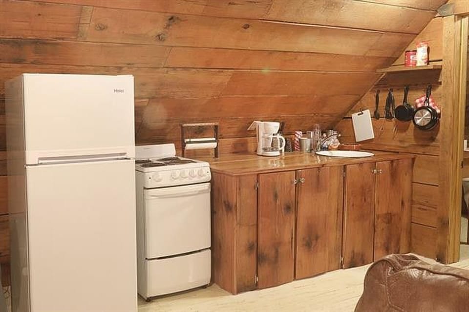 Upstairs kitchen with stove, oven, fridge and sink