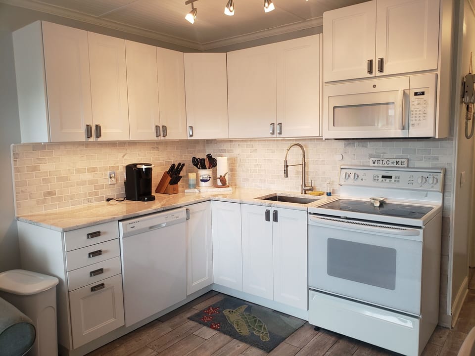 Kitchen, fully stocked. Beautiful granite counter, marble backsplash