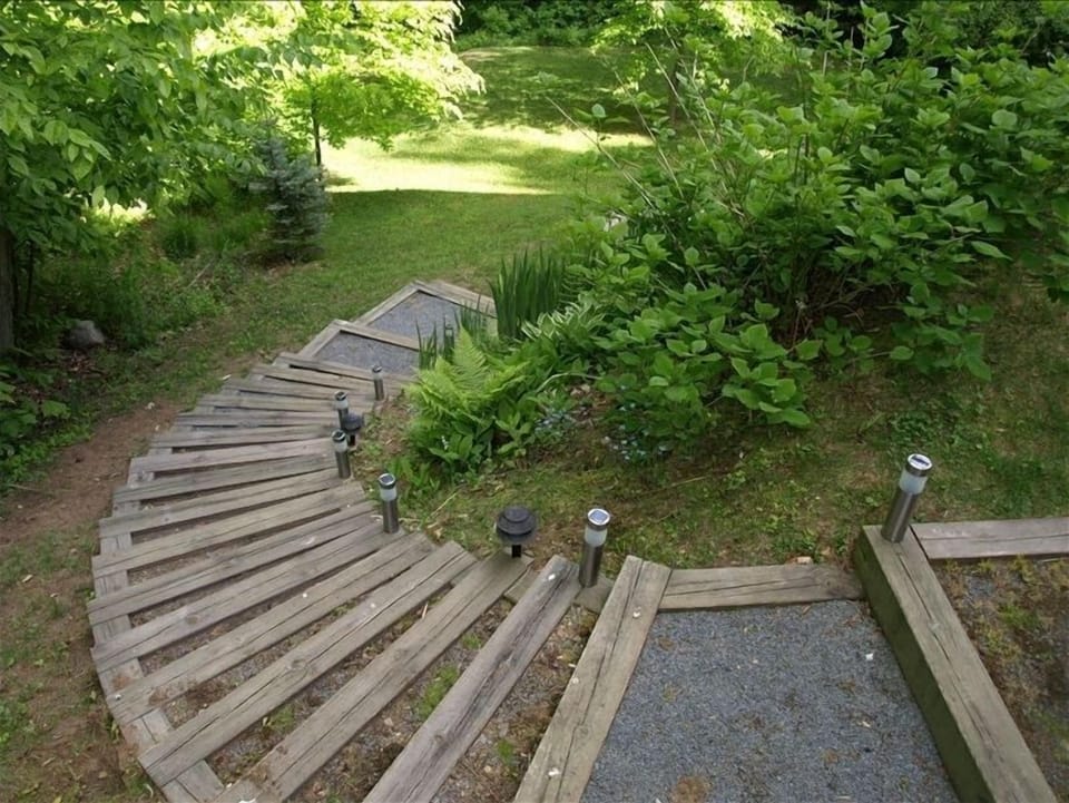 Stairs to the yard, gardens and lake.
