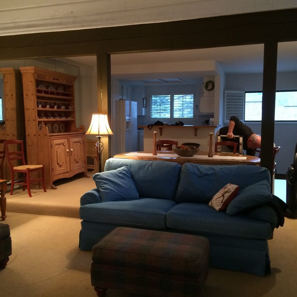 Upstairs living area, looking into the kitchen (please ignore bald guy working).