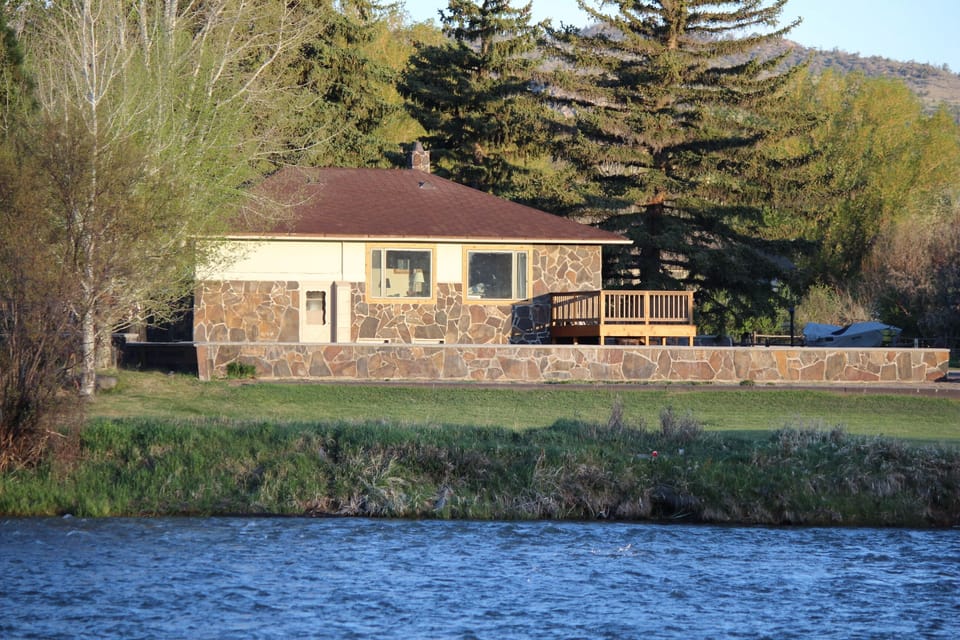 view of guest house from across river showing riverbank 