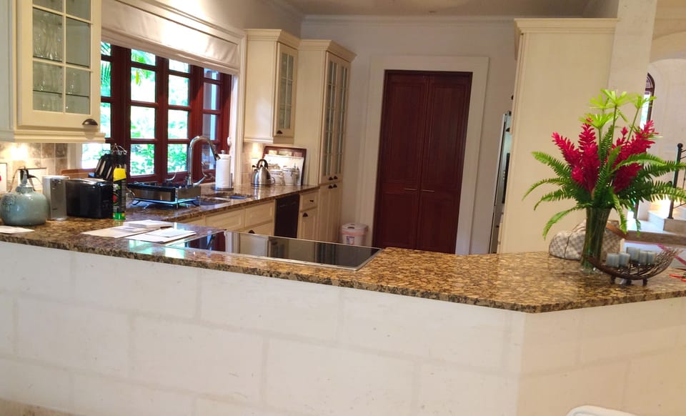 Kitchen with laundry and staff bathroom/ wet room to rear.
