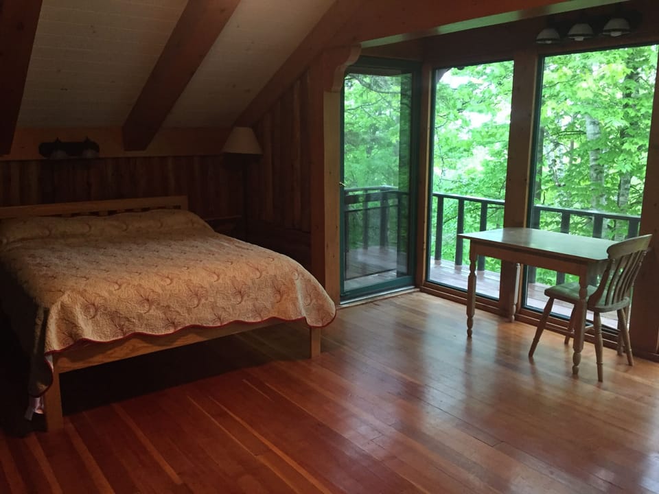 The queen bed in the upstairs bedroom.