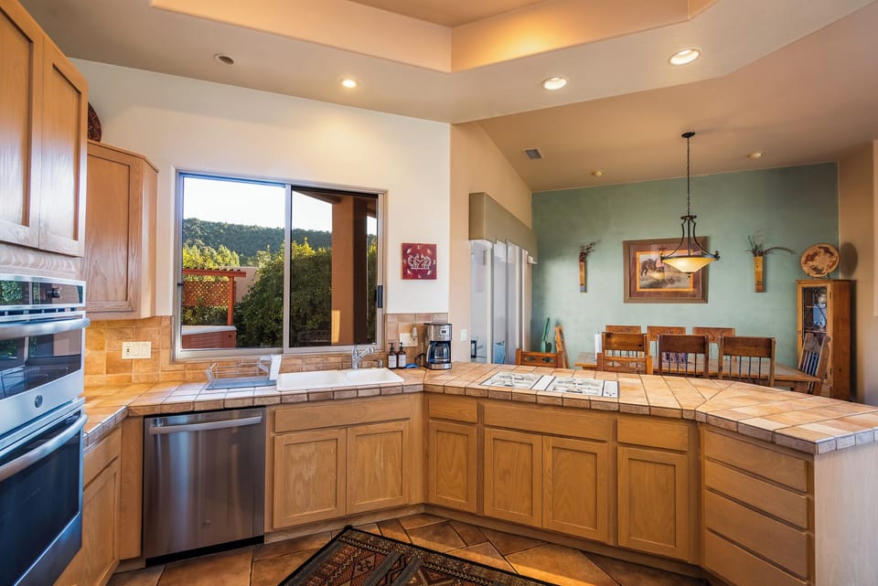 Kitchen with new appliances and drip coffee maker.