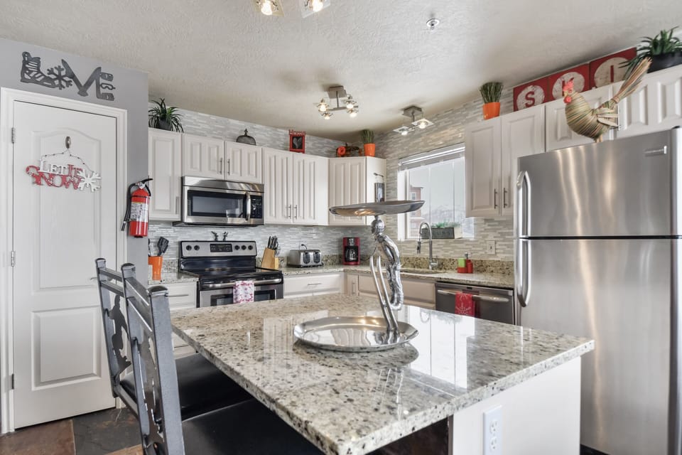 Kitchen with pantry, island & barstools