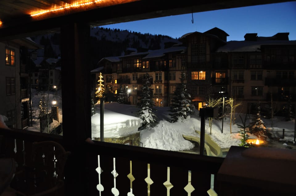 A view at night from the living room, note the 8' of snow on the pool house