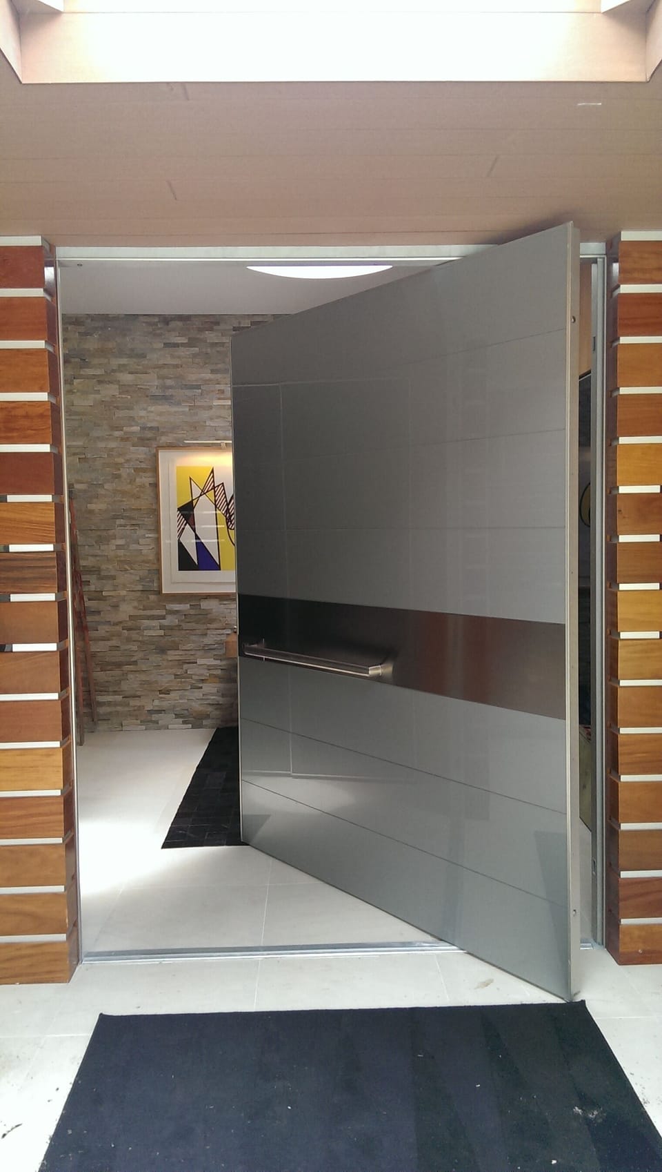 Enter through a massive 6' glass & steel pivoting door to an art-filled oasis.