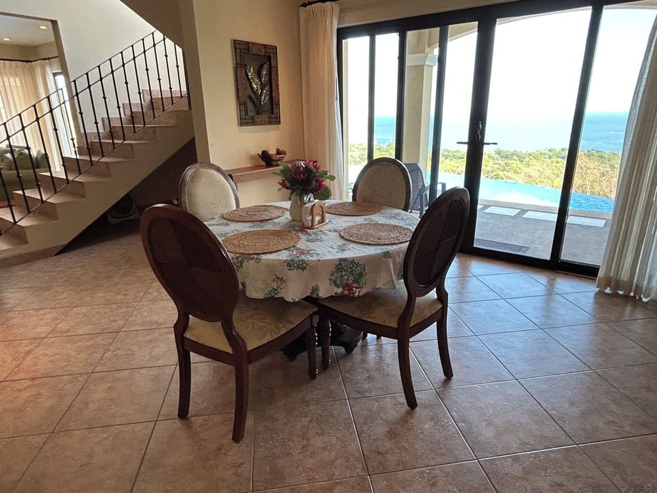 Dining area with walkout & view of pool and Gulf of Papagayo
