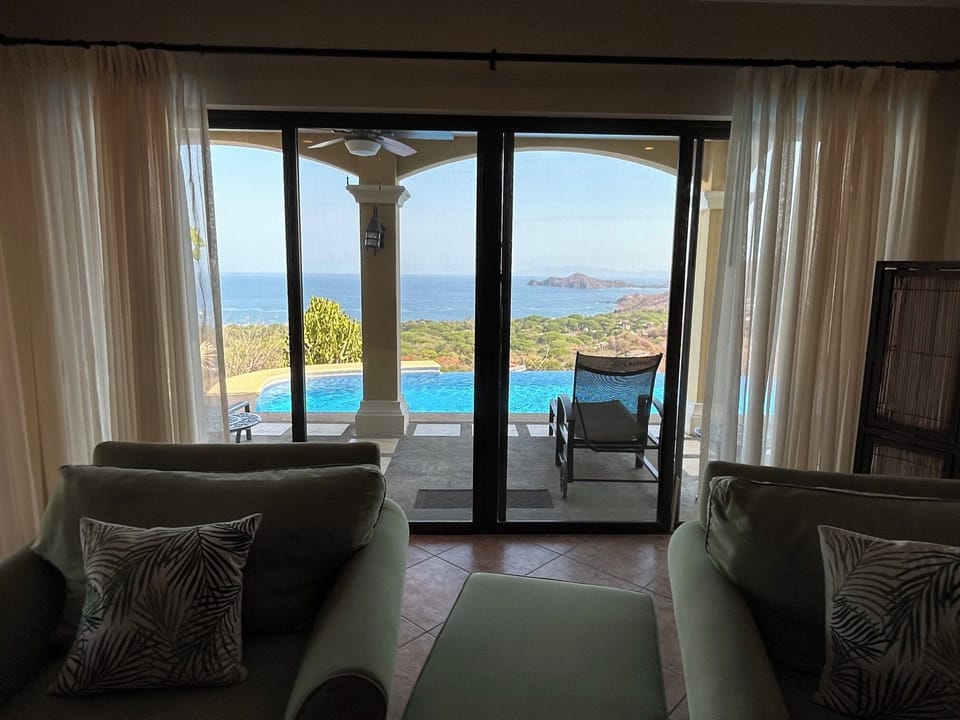 Living area with view of pool and Gulf of Papagayo and walkout