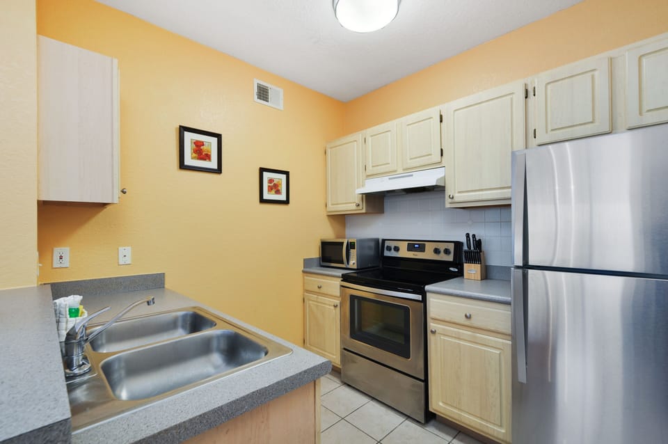 Kitchen with brand new stainless steel appliances.