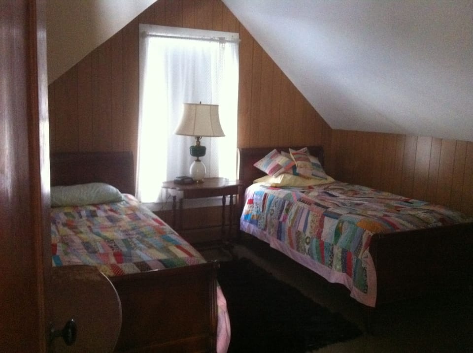 Twin beds in cozy room upstairs; we provide extra down comforter on each bed!