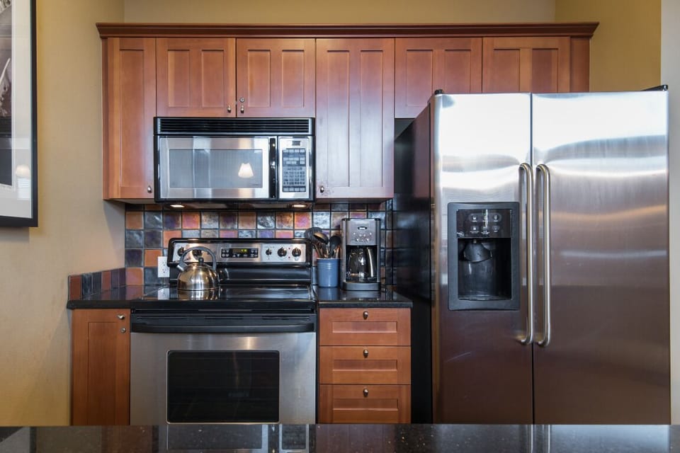 A modern kitchen outfitted with cuisinart and stainless steel appliances. 