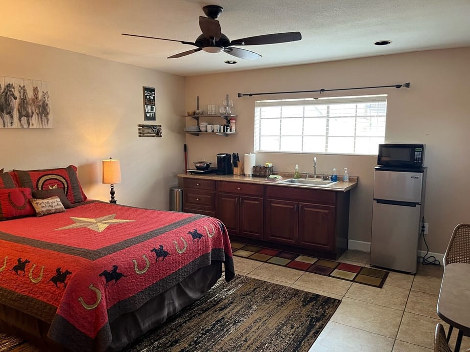 Kitchenette with coffee maker, refrigerator, microwave, cooking element