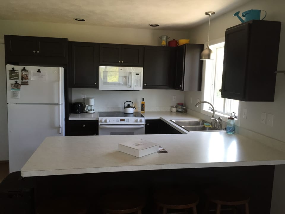 Kitchen with 4 bar stools at the large counter top