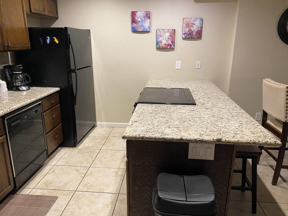 Large island with built-in stove and plenty of pots and pans for cooking. 