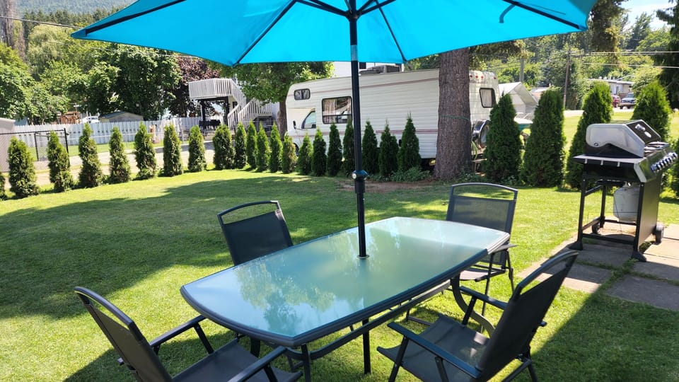 Back yard with barbeque, sitting area, and room to relax.