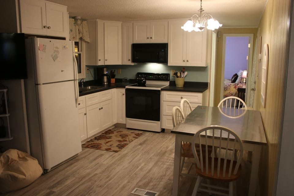 kitchen open to living room new floors and cabinets