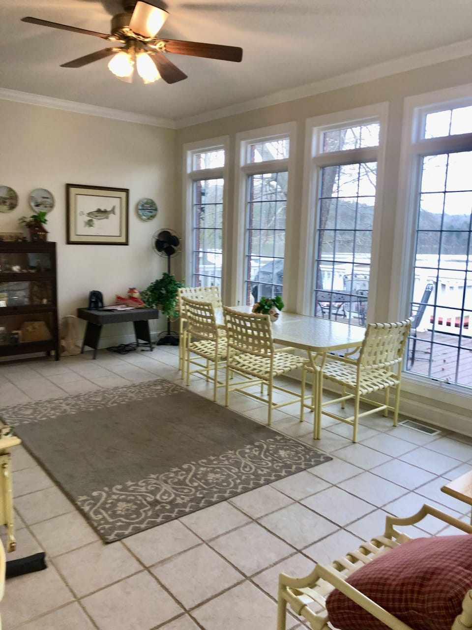 Sunroom w/ glider, table, chairs and lake view 