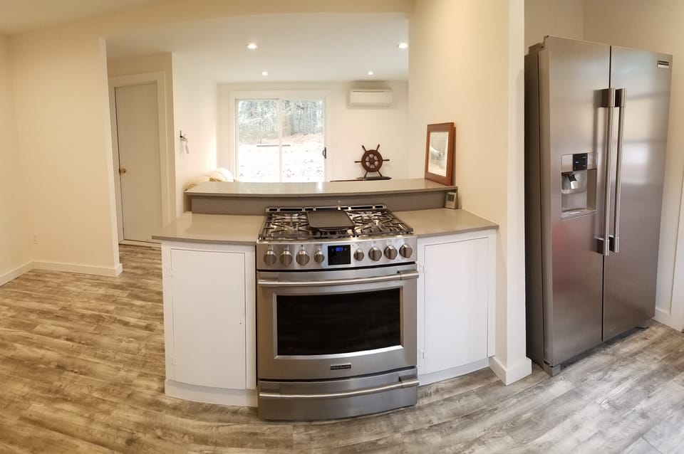 New gas stove top and double sided refrigerator.
