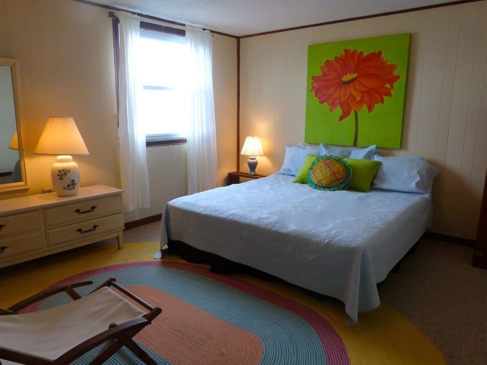 Oceanfront, king sized bedroom has easy access to lower level bathroom.