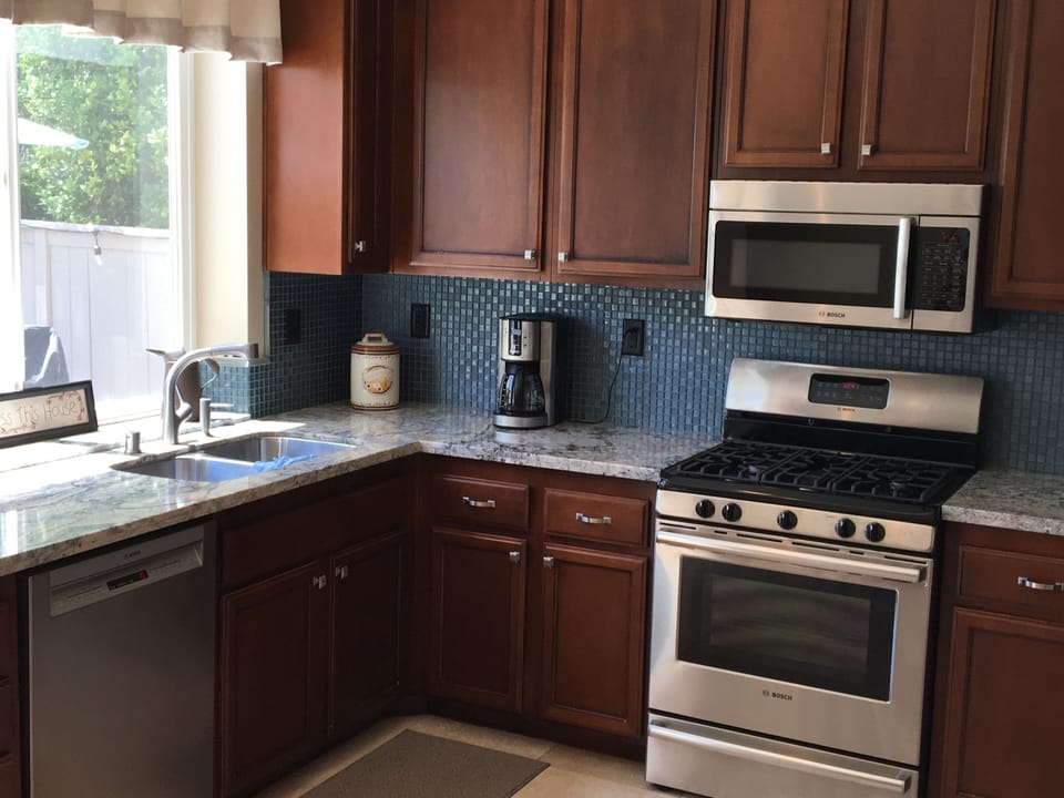 Bright open kitchen with new granite countertops.
