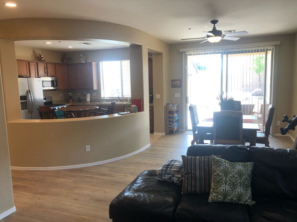 Great Room with Large Leather Sectional & luxury vinyl plank flooring