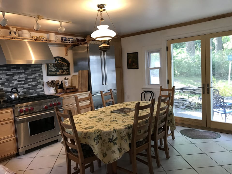 Kitchen w/ view of back patio w/ firepit and grill
